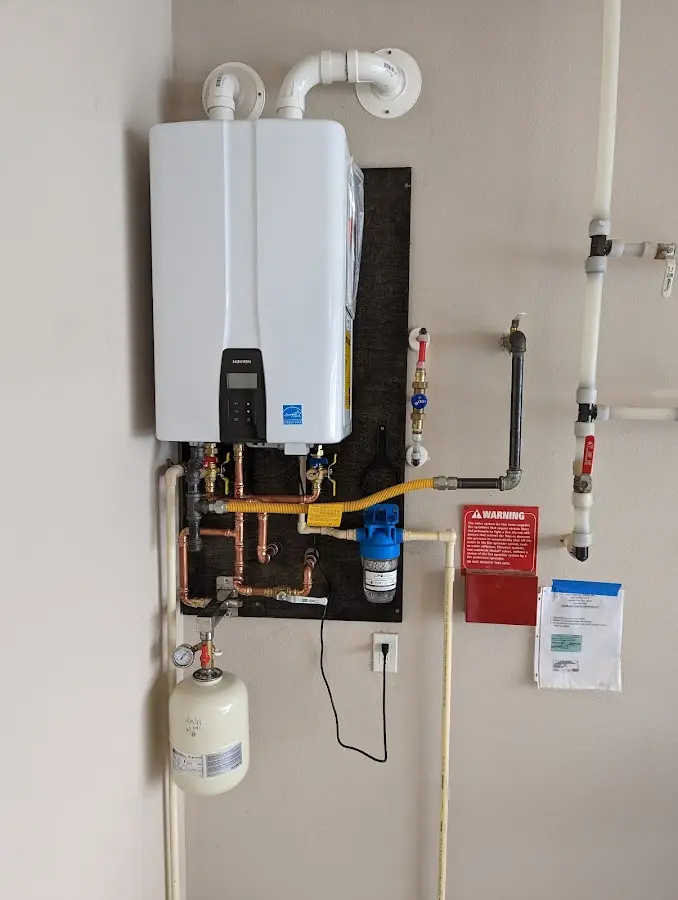 Professional plumber installing copper piping in a Bedminster home